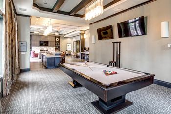 Recreation room with pool table and mounted tvs